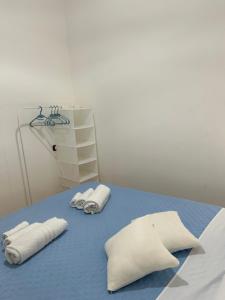 two towels are sitting on a blue bed at A casa ru zu Nino in Capaci