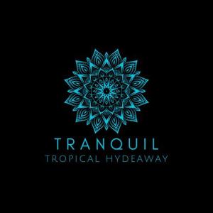 un logotipo de mandala azul en un fondo negro en TRANQUIL Tropical Hideaway en Kaduwela