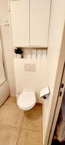 a small bathroom with a toilet and a cabinet at Chic & Cosy apartment - 60m2, 3 rooms in Asnières-sur-Seine