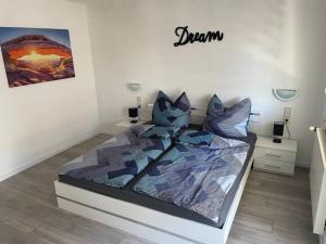 a bedroom with a bed with blue pillows on it at Sofi Wohnung in Reutlingen