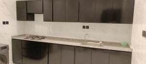a kitchen with a sink and a counter top at Al Amer Apartment2 in Jeddah