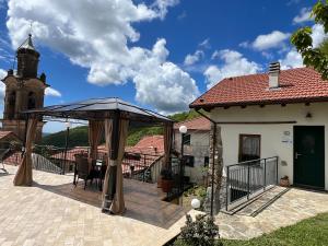 a patio with a gazebo next to a building at Agriturismo Cascina Clavarezza in Valbrevenna