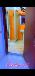 a bathroom with a shower and a toilet and a sink at Chez Anta in Dakar