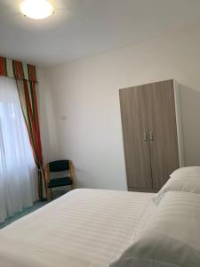 Postel nebo postele na pokoji v ubytování Hotel Conte