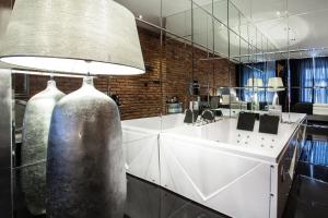 a kitchen with a sink and a large mirror at Hotel Betmanowska Main Square Residence Adults Only in Krakow