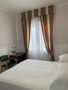 Postel nebo postele na pokoji v ubytování Hotel Conte