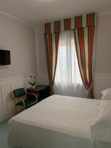 Postel nebo postele na pokoji v ubytování Hotel Conte