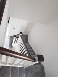 a staircase in a house with white walls and wooden railings at Room in Limerick in Limerick