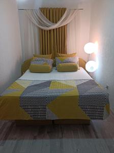 a bedroom with a bed with a colorful bedspread at Kavkaz Apartment in Sarajevo +22 photos