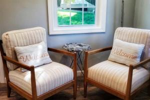 two chairs and a table in a room with a window at The Whalewalk Inn & Spa in Eastham