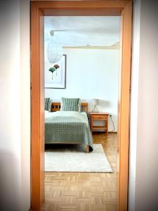 a bedroom with a bed with a green bedspread at Franziskaner Suites #9 in Graz