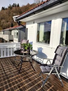 a patio with a table and chairs on a deck at Nearby Bergen in Bergen