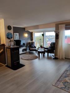 a living room filled with furniture and a large window at Nearby Bergen, Midtunlia 27d in Bergen