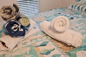a bed with towels and pillows on it at *NEW* POOL screened-in, Waterfront, 4 Kayaks, Pet in Hernando Beach