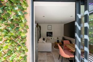 a living room and dining room with a sliding glass door at Honey Moon - studio romantique Jacuzzi et écran cinema in La Ciotat