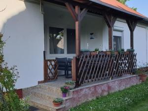 a house with a porch with a fence at Sophie Apartment in Balatonberény