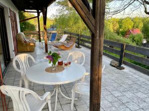 a white table and chairs on a patio at Przystanek Zawadka in Zawadka