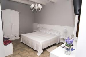 1 dormitorio con 1 cama blanca y armario blanco en Masseria Gravelle, en Turi