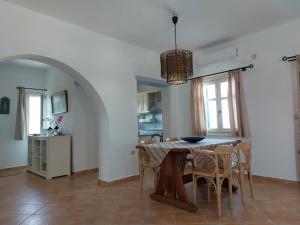 a kitchen and dining room with a table and chairs at Maritina's house top floor in Kamárion +11 photos