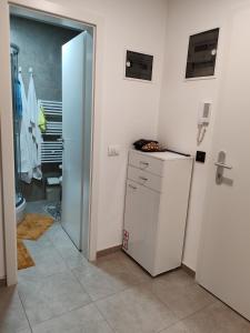 a bathroom with a refrigerator and a toilet in it at Apartman Max in Modriča