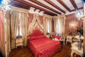 a bedroom with a red bed and curtains at Dimora Dogale in Venice