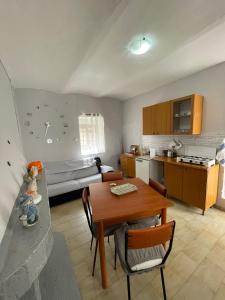 eine Küche und ein Wohnzimmer mit einem Tisch im Zimmer in der Unterkunft CASA COLLINARE Rifugio nel Cuore dell'Abruzzo 