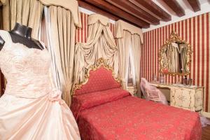 a bedroom with a bed and a wedding dress on display at Dimora Dogale in Venice +26 photos