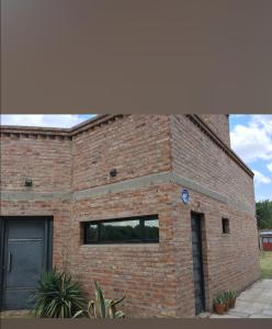 a brick building with a window and a door at Josefina casa in Punta Alta