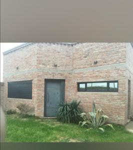 a brick building with a door and a window at Josefina casa in Punta Alta