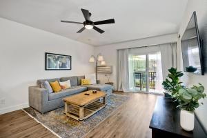 a living room with a couch and a table at Beautifully Remodeled - Private Balcony - Pool View - BBQ Access - Gated Reserved Parking in Encinitas