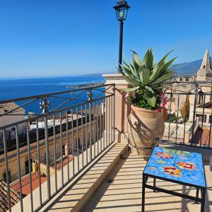 a balcony with a bench and a view of the ocean at Casa Turchetti in Taormina