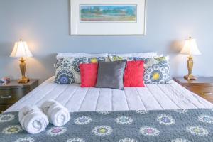 a bedroom with a bed with towels on it at Islander East Condominiums in Galveston