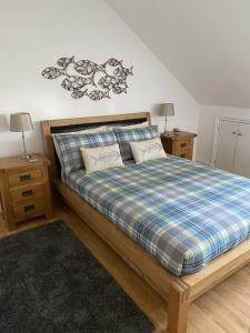 a bedroom with a large bed with two night stands at Bryher in Wadebridge