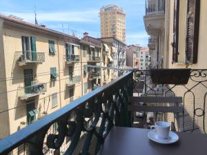 a cup of coffee sitting on a table on a balcony at Cherry rooms in La Spezia