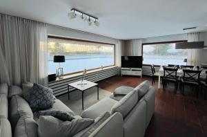 a living room with a couch and a large window at Landhus-Sylt in Archsum