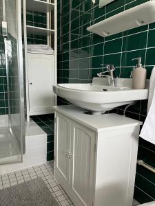 a bathroom with a sink and a toilet and a shower at Landhus-Sylt in Archsum