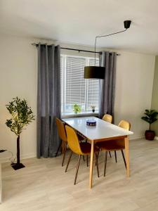 a dining room with a table and chairs and a window at 5 minute walk to LEGO house - 50m2 cozy apartment- D unit in Billund