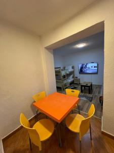 comedor con mesa y sillas amarillas en Necaj Apartment, 