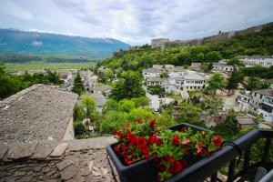 a view of a town from a balcony with flowers at Emblematic House Apartment 2 in Gjirokastër