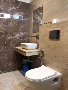 a bathroom with a white toilet and a sink at Hampton Hotel - 100 mt from Golden Temple in Amritsar