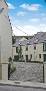 a large white house with a cobblestone street at Mardan House B&B in Killybegs