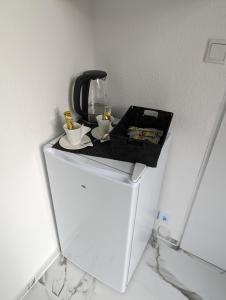a white refrigerator with two cups on top of it at Studio 1 in Bremen