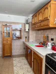 a kitchen with wooden cabinets and a sink at Bab Ezzouar in Bab Ezzouar
