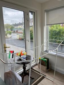 a room with a balcony with a table and a window at Kilmactrasna Cottage in Carrickmacross