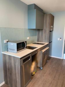 a kitchen with a microwave on a counter top at La Quinta by Wyndham Parnell Auckland in Auckland