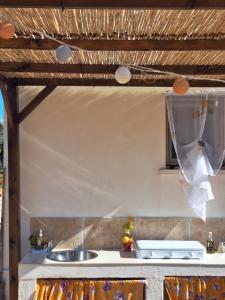 a kitchen with a sink and a counter top at Residenza Anima Mediterranea in Francavilla Fontana +35 photos