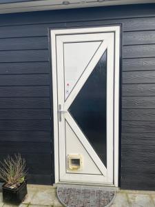 a door with a triangle on the side of a garage at Private room with shared bathroom in central of billund in Billund