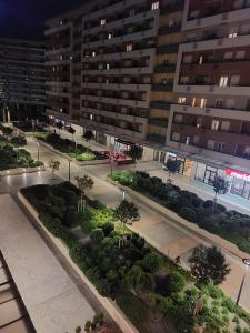 an empty street in front of a large building at Comfort Central Point apartment in Podgorica