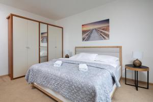 a bedroom with a large bed and a table at Apartments Green Garden in Opatija +67 photos
