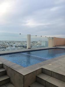 a swimming pool on the roof of a building at Iveria Hotel Apartments in Ḩayl Āl ‘Umayr